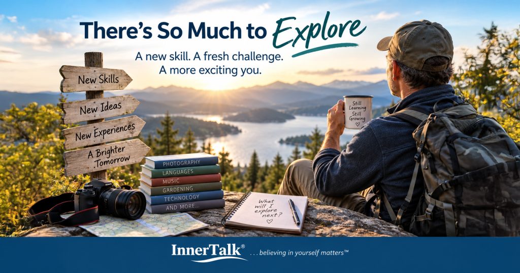 Older man overlooking a mountain lake with books, camera and notebook representing learning, growth and new experiences.